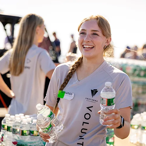 Female volunteer handing out water